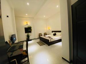 a bedroom with a bed and a television in it at Ceylon Avenue in Habaraduwa Central