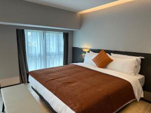 Un ou plusieurs lits dans un hébergement de l'établissement LlA Hotel Liang Jun Plaza, Xixiang Avenue