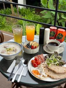 a table with a plate of food and some drinks at The Episode Boutique Hotel in Suratthani +25 photos