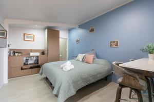 1 dormitorio con paredes azules y 1 cama con toallas. en L'Air du Wombat Truffle Farm, en Corang