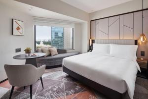 a hotel room with a bed and a couch at ANA InterContinental Tokyo by IHG in Tokyo