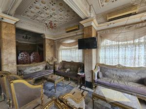 a living room with couches and a flat screen tv at Rasheed International Hotel - Families Only in Rashīd +30 photos