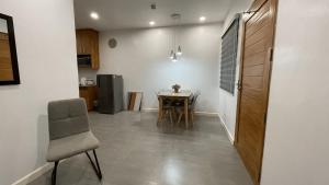 a kitchen and dining room with a table and chairs at Cozy Cottage in Kabankalan