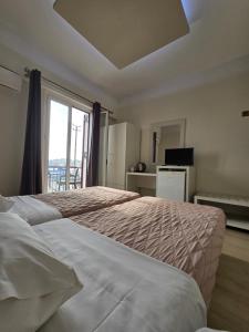 Posteľ alebo postele v izbe v ubytovaní Aegean Sea Rooms