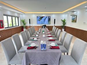 a long dining room with a long table and chairs at Hoang Yen Boutique Hotel in Dien Ban +63 photos
