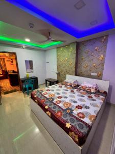 a bedroom with a large bed with a blue ceiling at PG Homes in Port Blair