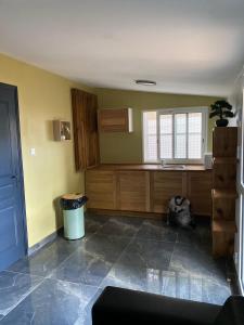 a kitchen with wooden cabinets and a window at Cazemiel in Tsingoni +7 photos