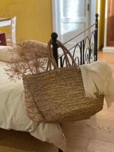 a basket sitting on the side of a bed at B&B MELLONI STREET in Dolo