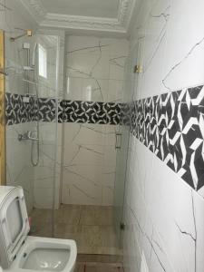 a bathroom with a shower and a toilet at Green house heaven in Kribi +50 photos
