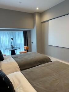 Un ou plusieurs lits dans un hébergement de l'établissement LlA Hotel Liang Jun Plaza, Xixiang Avenue