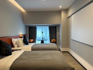 Un ou plusieurs lits dans un hébergement de l'établissement LlA Hotel Liang Jun Plaza, Xixiang Avenue