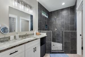 a bathroom with a double sink and a shower at Luxury Retreat near St. Andrews in Panama City Beach +8 photos