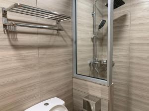 a bathroom with a toilet and a glass shower at T Lodge, Kapit in Kapit +55 photos