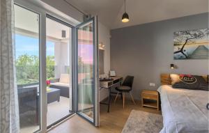 a bedroom with a bed and a desk and a balcony at Villa Lucas in Pula
