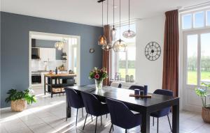 a dining room with a black table and chairs at Lovely Home In Ovezande With Sauna in Ovezande