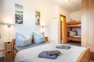 ein Schlafzimmer mit einem Bett mit zwei Handtüchern darauf in der Unterkunft Haus Frohsinn - Wohnung 3 in Binz