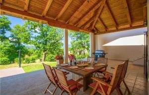 a wooden table and chairs on a patio at Villa Vesna in Buzet +50 photos
