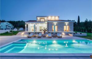 a house with a swimming pool in front of a house at Villa Ena Mar in Zadar