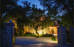 a house with a tree in the yard at night at Villa Kringa in Kučići +35 photos