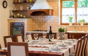 a long table with glasses and a bottle of wine at Villa Kringa in Kučići