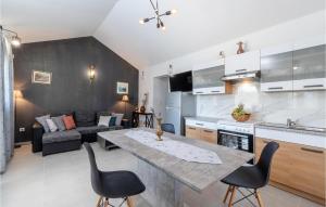 a kitchen and living room with a table and chairs at 2 Bedroom Gorgeous Home In Smokvica in Smokvica