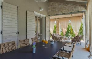 a dining room with a table and chairs at Villa Calma in Šivati
