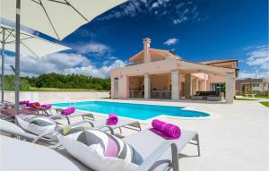 a villa with a swimming pool and lounge chairs at Villa Liv in Pula +52 photos