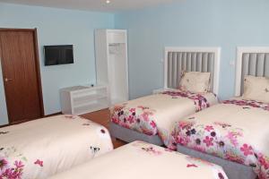 Cama ou camas em um quarto em Grande Oceano Guest House