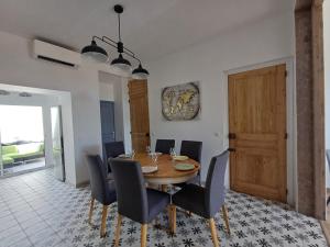 a dining room with a wooden table and chairs at Villa Maris Stella à 250m de la plage de Petit Fort Philippe in Gravelines +21 photos