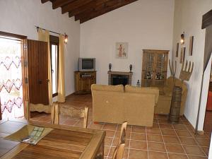 a living room with a couch and a table at Villa Marta Clara in Conil de la Frontera