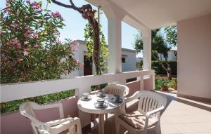 a patio with a table and chairs on a balcony at 2 Bedroom Awesome Apartment In Pag in Pag +23 photos