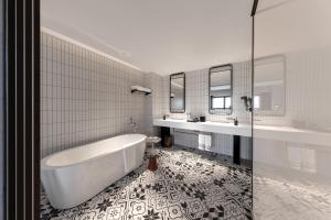 a bathroom with a tub and two sinks at Wanda Moments Hotel Beijing Dongba in Beijing +37 photos