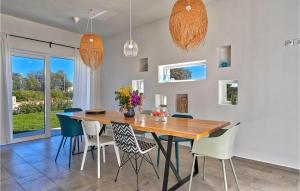 a dining room with a wooden table and chairs at Villa Vela Muline in Zadar