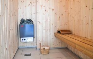 a room with a tv on a wooden wall at Stunning Home In Gilleleje With Sauna in Gilleleje