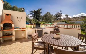 a patio with a table and a fireplace at Lovely Home In Chiclana De La Fronter in Chiclana de la Frontera +23 photos