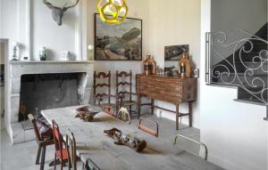 a living room with a table and a fireplace at Amazing Home In Léognan With Sauna in Léognan