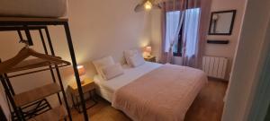 a small bedroom with a white bed and a window at Gîte Xuritenborda 7 personnes avec vue exceptionnelle sur les montagnes basque, Lits 180 King Size in Ossès