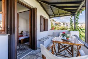 an outdoor patio with a table and chairs at Studios Elpiniki in Skopelos Town