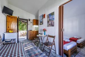 a room with a bedroom with a table and a bed at Studios Elpiniki in Skopelos Town