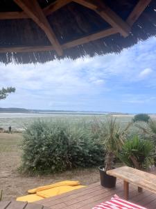 a view of the ocean from a deck with a bench at Appartement Lancieux in Lancieux +3 photos