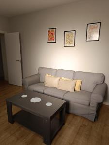 a living room with a couch and a coffee table at Apartamento Barbadillo - Redmansur in Cáceres