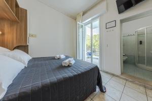 Posteľ alebo postele v izbe v ubytovaní Hotel Stacchini