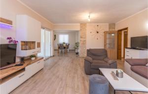salon z kanapą i telewizorem w obiekcie Cozy Home In Biograd Na Moru w Biogradzie na Moru