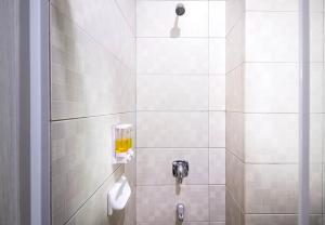 a bathroom with a shower with a toilet at Hotel 88 - Mangga Besar VIII Jakarta By WH in Jakarta +36 photos
