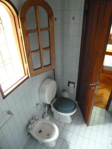 a bathroom with a toilet and a sink at Hostel de Los Artistas in Mendoza +26 photos