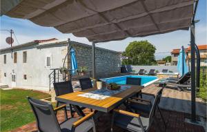 a patio with a table and chairs and a pool at Villa Imela in Pula