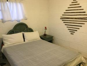 a bedroom with a bed and a staircase in the wall at Casa Emilia in Curití