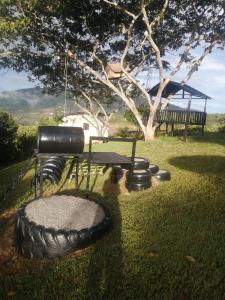 a large tire sitting in the grass next to a playground at Casa Emilia in Curití