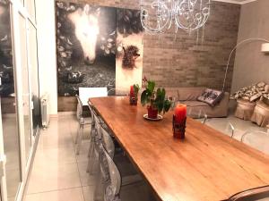 a dining room with a wooden table and a chandelier at Маєток Ліс і Гори in Bukovel +131 photos