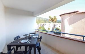a table and chairs on a balcony with a view at Cozy Apartment In Nocera Terinese in Nocera Terinese +8 photos